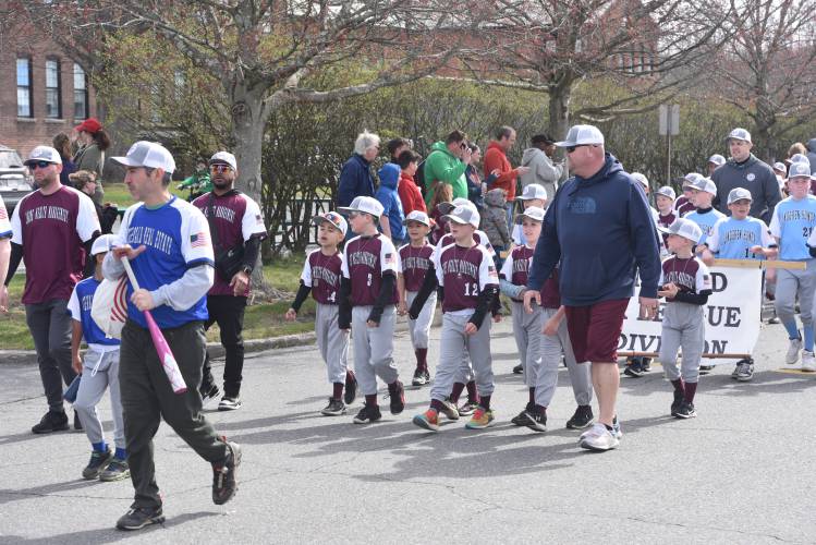 Greenfield Minor League baseball players make their way to Lunt Field during its Opening Day parade Sunday.