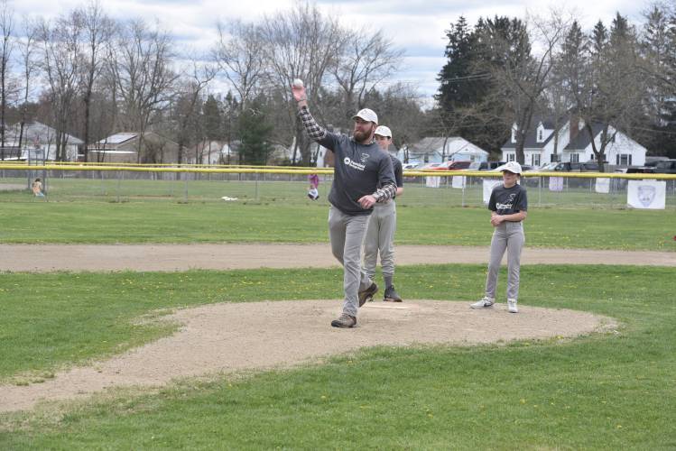 Cody Guilbault throws out the first pitch with his son, Matt Guilbault, and his daughter, Brenna Guilbault, on Sunday in Turners. 