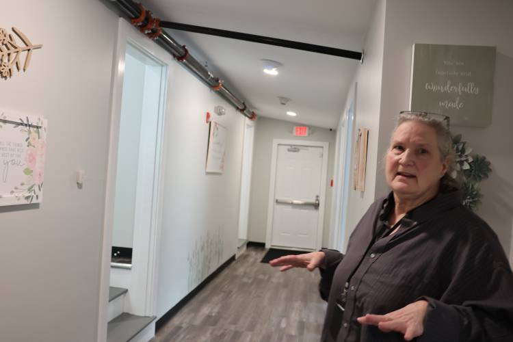 Liz Beach, the program director at Sunrise Ridge in Athol, walks through the facility, which has space for 32 patients. Sunrise Ridge works with women with substance use and mental health disorders.
