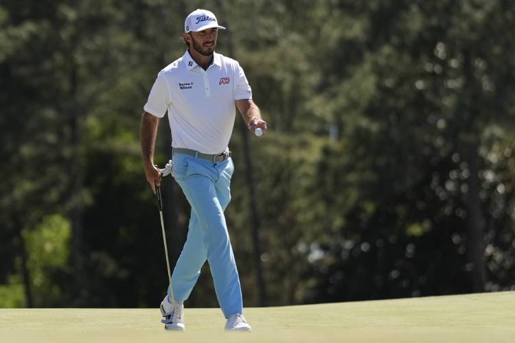 Max Homa waves after making a putt on the 18th hole during second round at the Masters golf tournament at Augusta National Golf Club Friday, April 12, 2024, in Augusta, Ga. (AP Photo/Ashley Landis)