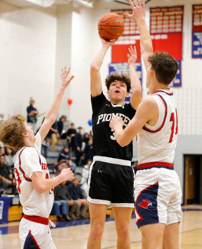 Pioneer’s Kurt Redeker (3) puts up a shot over Frontier defenders Jack Carey (13) and Owen Babb (14) in the first quarter Friday night at Goodnow Gymnasium in South Deerfield.
