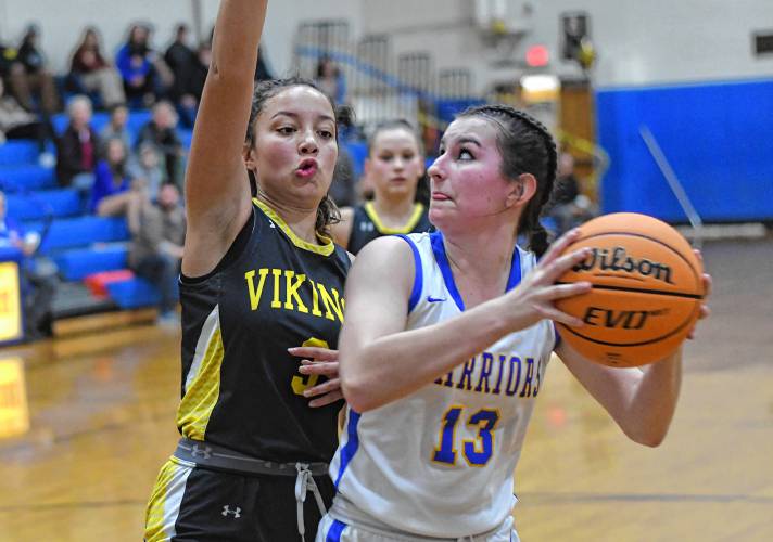 Mohawk Trail’s Riley Giard (13) is defended by Smith Voc’s Jayanna Daniels in Buckland Thursday night.