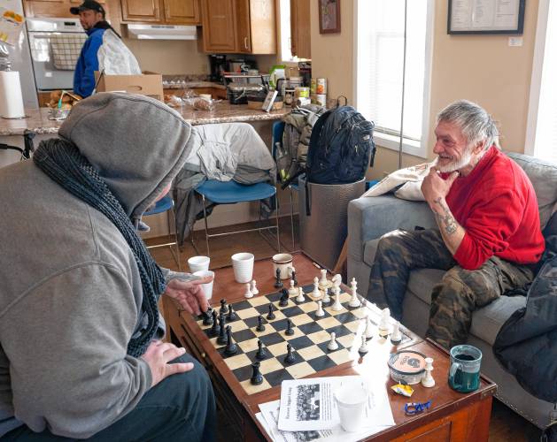 Christopher Cardinale and Michael Bricault play chess at the Wildflower Alliance Bowen Center in Springfield.