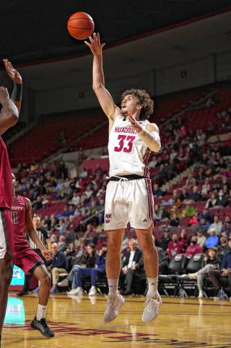 UMass’ Matt Cross (33) puts up a shot against St. Joseph’s during Atlantic 10 Conference action on Tuesday night at the Mullins Center in Amherst.