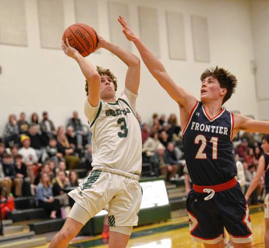 Greenfield’s Oliver Postera (3) shoots past Frontier’s Luke Howard during Hampshire League South action at Nichols Gymnasium in Greenfield on Tuesday evening.