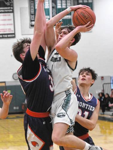 Greenfield’s Jacob Blanchard tries to split two Frontier defenders during Hampshire League South action at Nichols Gymnasium in Greenfield on Tuesday evening.