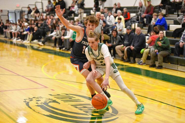 Greenfield’s Grayson Thomas drives to the basket while defended by Frontier’s Alexander Ellis during Hampshire League South action at Nichols Gymnasium in Greenfield on Tuesday evening.