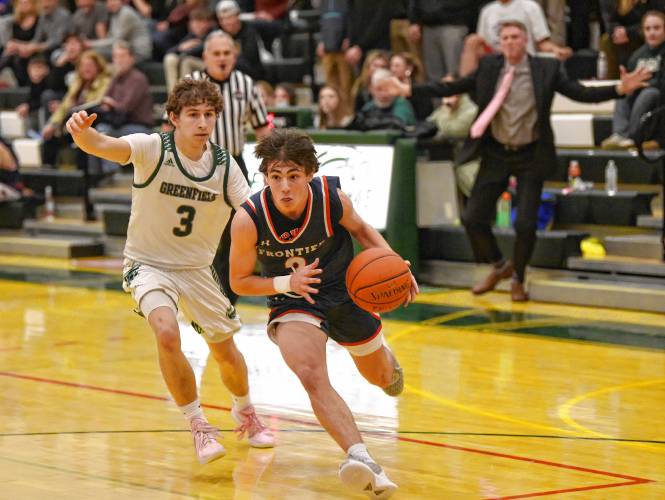 Frontier’s Nico Fasulo, right, drives while defended by Greenfield’s Ollie Postera during Hampshire League South action at Nichols Gymnasium in Greenfield on Tuesday evening.