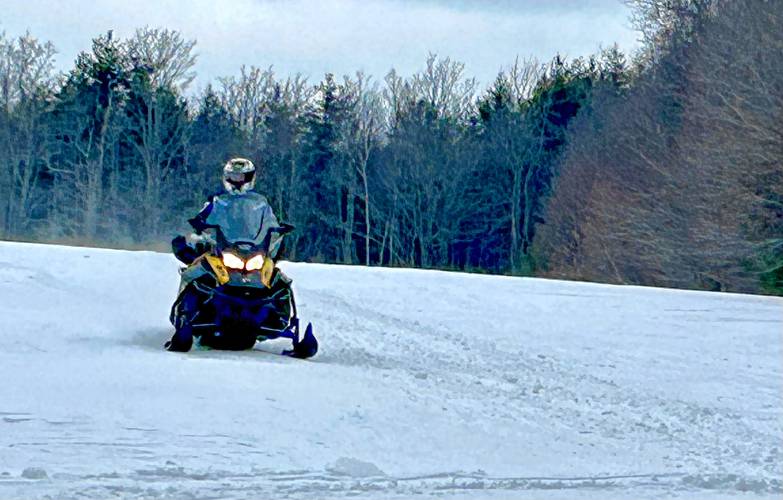 Steven Howland, president of the Buckland Riders Snow Mobile Club, riding on the snowmobile trail system near his home. Snowmobiles can go up to 60 mph, but they typically drive 20 to 30 mph on trails.