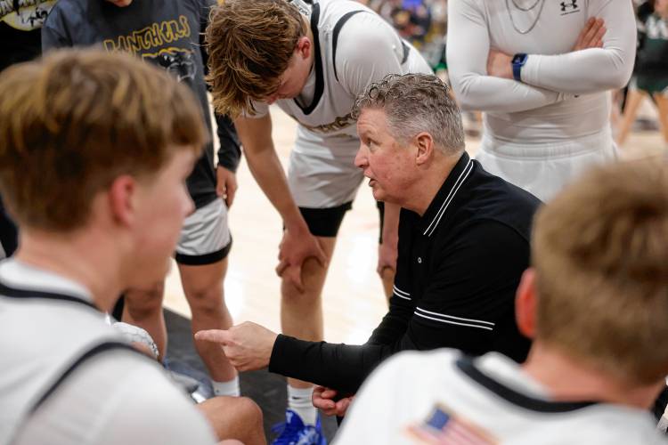 Pioneer head coach Scott Thayer talks with his team during the MIAA Division 5 quarterfinal game against Ware on Friday night in Northfield.