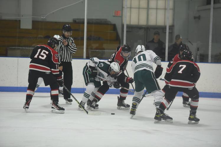 Greenfield's Shawn Baumann wins a faceoff against Westfield at Collins-Moylan Arena on Wednesday. 